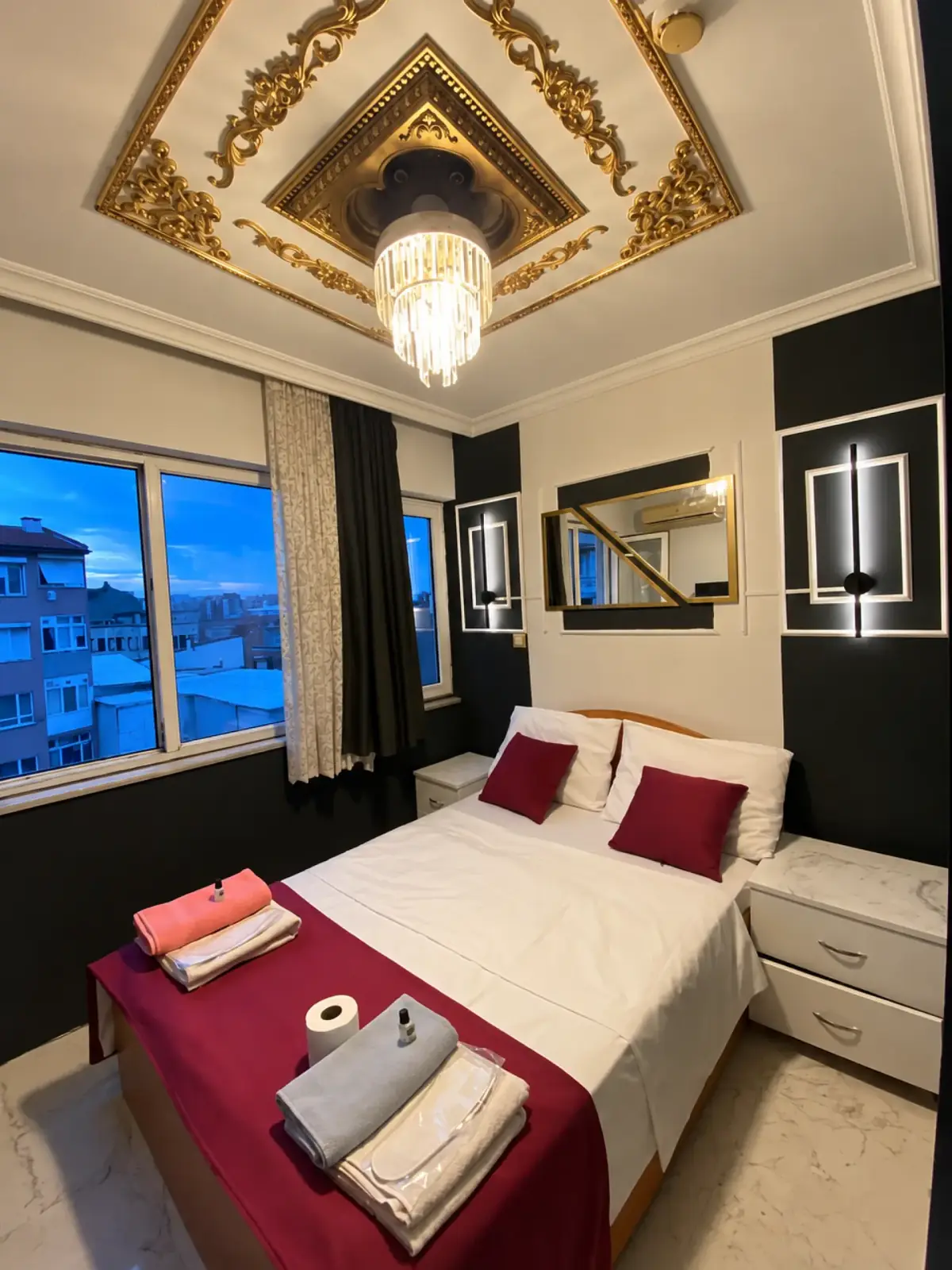 Double bedroom with ornate ceiling at Petek Hotel